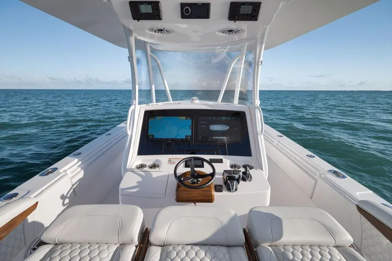 Slide: The Image of Manufacturer Provided Image: 2026 Contender 39 ST boat helm with ocean view, featuring advanced navigation systems. - 6