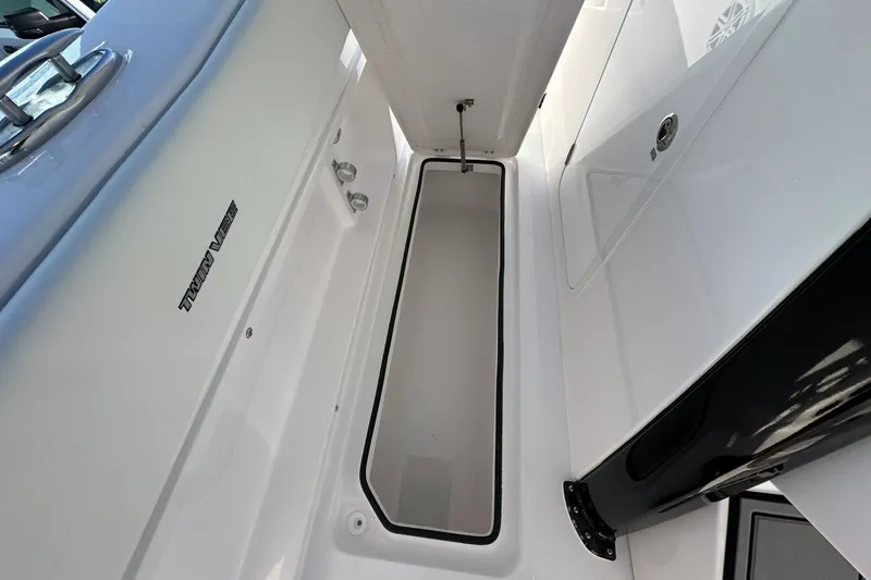 Slide: The Image of 2026 Twin Vee 280 GFX2 CC boat interior storage compartment, sleek design. - 13