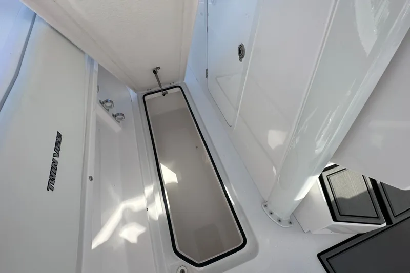 Slide: The Image of 2026 Twin Vee 280 GFX2 CC boat interior, featuring sleek white storage compartment. - 9