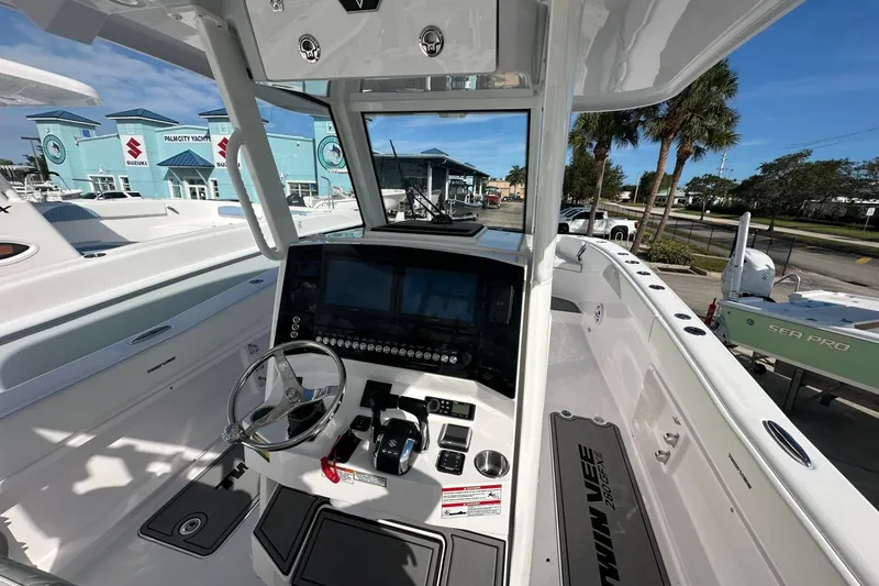 Slide: The Image of 2026 Twin Vee 280 GFX2 CC boat interior with modern dashboard and steering wheel. - 3