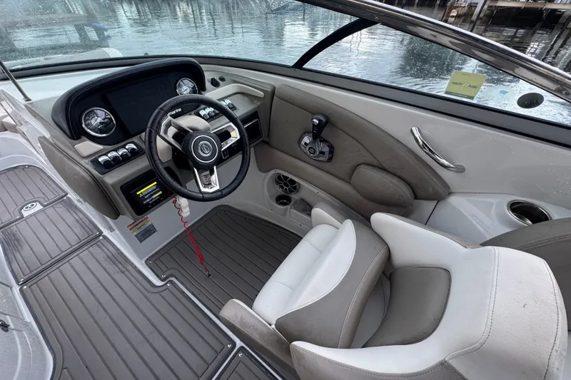 Slide: The Image of 2019 Crownline Eclipse E275 XS boat cockpit with steering wheel and controls. - 5