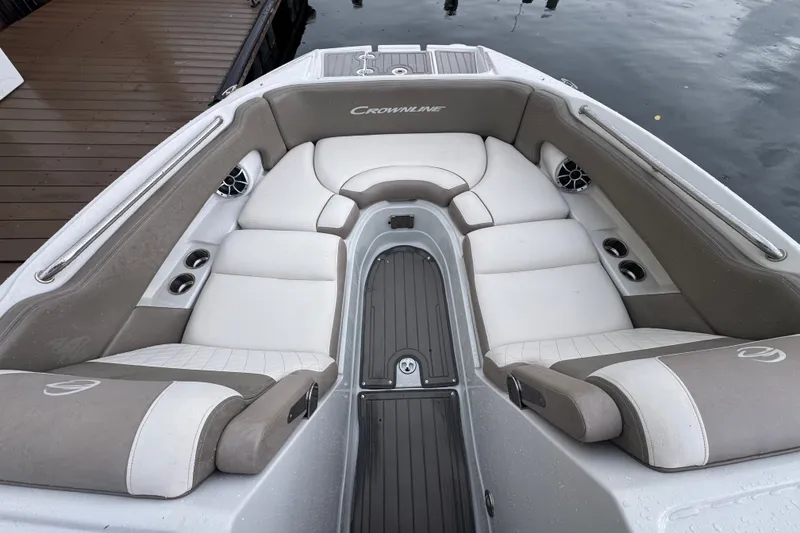 Slide: The Image of 2019 Crownline Eclipse E275 XS boat interior with cushioned seating and cup holders. - 7