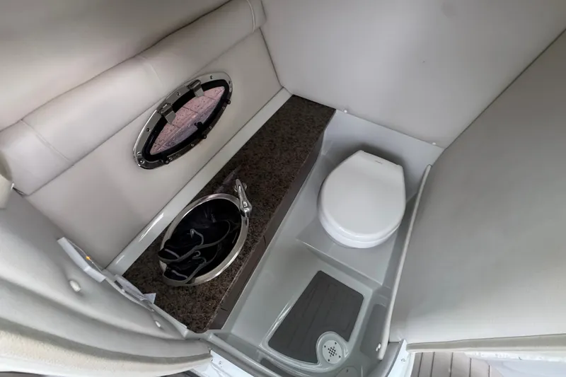 Slide: The Image of 2019 Crownline Eclipse E275 XS boat interior bathroom with toilet and sink. - 8