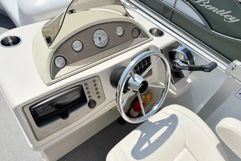 Slide: The Image of Steering console of a 2009 Crest 20 Caribbean boat with gauges and controls. - 7