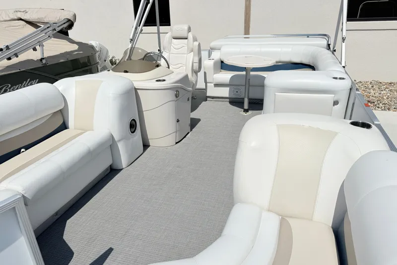 Slide: The Image of 2009 Crest 20 Caribbean pontoon boat with white seating and a central table. - 4