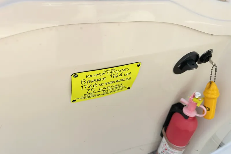 Slide: The Image of 2009 Crest 20 Caribbean boat capacity label with fire extinguisher and safety equipment. - 8