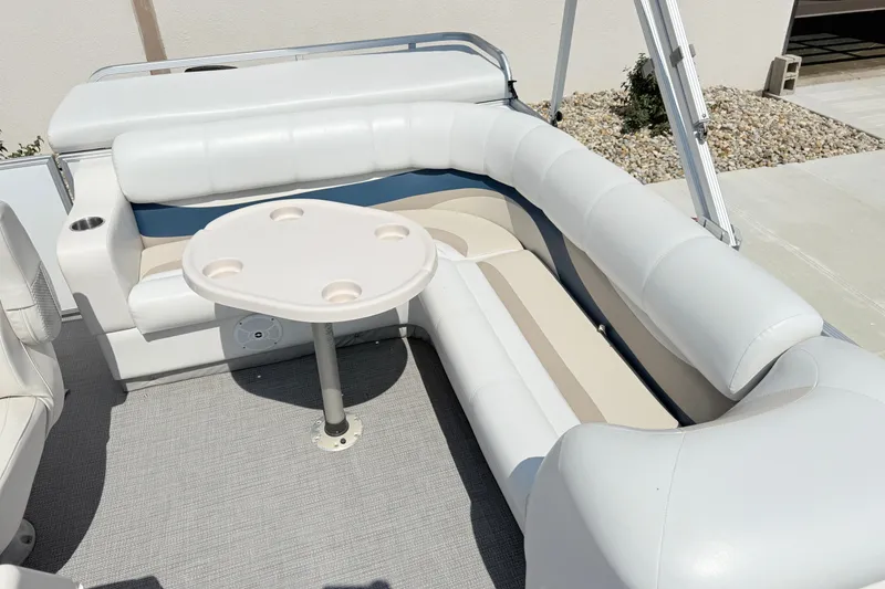 Slide: The Image of 2009 Crest 20 Caribbean boat interior with white seating and round table. - 6