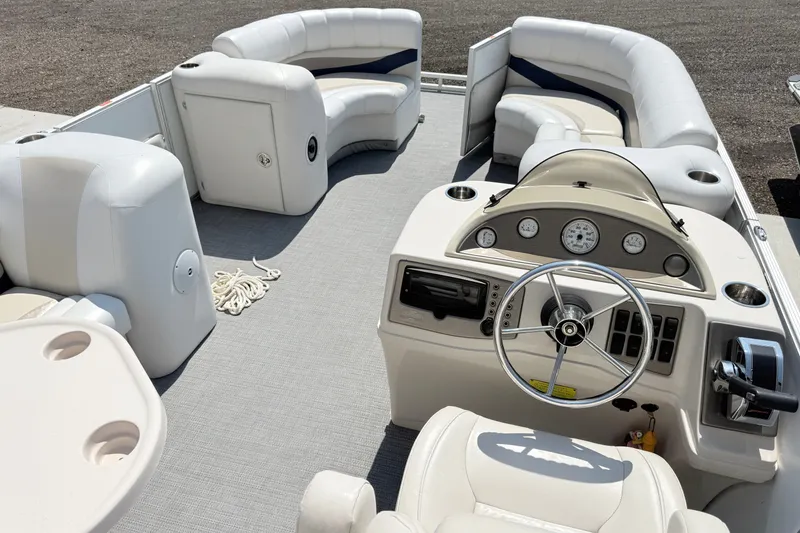 Slide: The Image of Interior of a 2009 Crest 20 Caribbean boat with steering wheel and seating. - 11