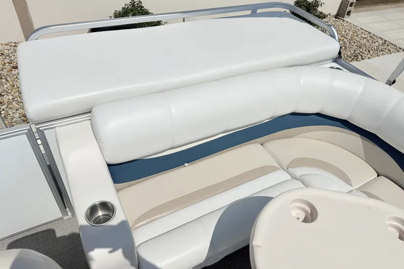Slide: The Image of 2009 Crest 20 Caribbean boat interior with white cushioned seating and cup holder. - 9