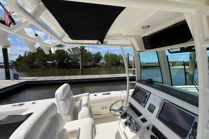 Slide: The Image of Interior view of a 2011 Boston Whaler 320 Outrage boat at a dock. - 16