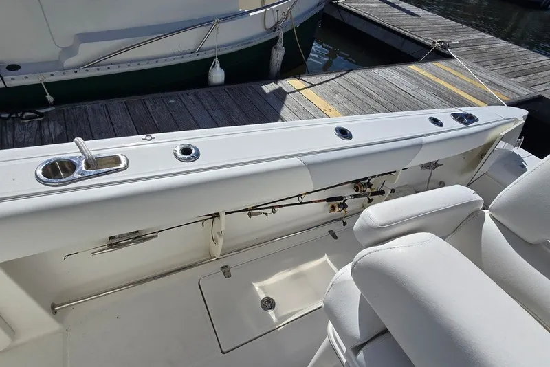 Slide: The Image of 2011 Boston Whaler 320 Outrage boat interior with fishing rod holders and seating. - 33