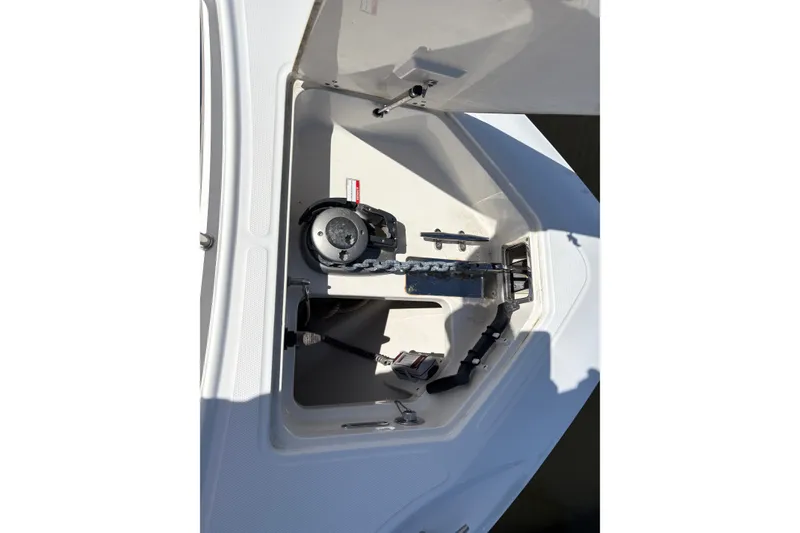 Slide: The Image of Anchor compartment of a 2011 Boston Whaler 320 Outrage boat, featuring chain and winch. - 47
