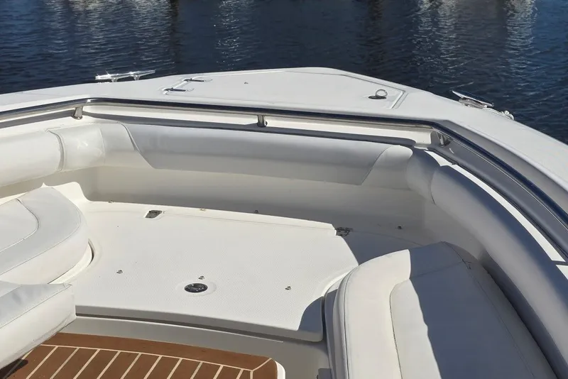 Slide: The Image of 2011 Boston Whaler 320 Outrage boat interior with white seating and stainless steel railings. - 32