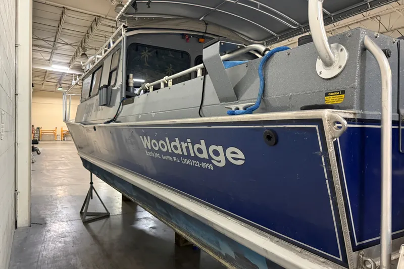 Slide: The Image of 2012 Wooldridge 29 Super Sport Pilothouse boat in indoor storage facility. - 3
