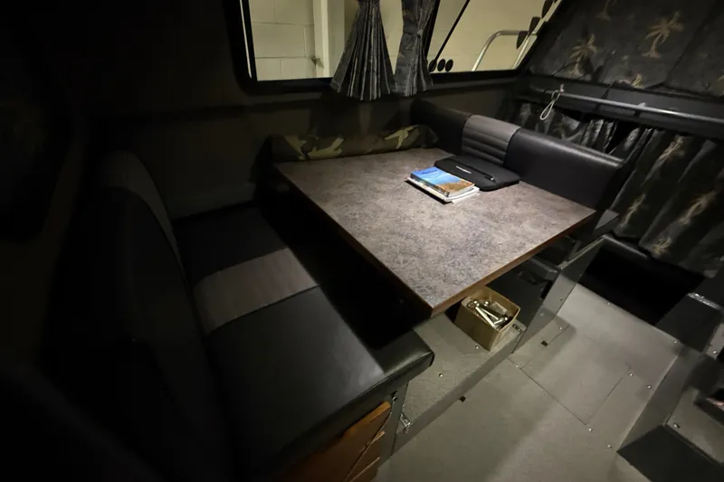 Slide: The Image of Interior of 2012 Wooldridge 29 Super Sport Pilothouse with table and seating area. - 23