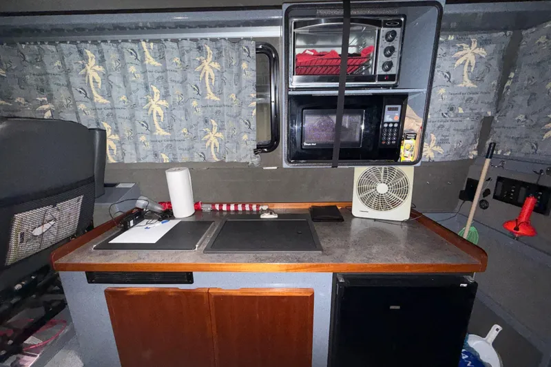Slide: The Image of Compact kitchen area in a 2012 Wooldridge 29 Super Sport Pilothouse boat. - 11