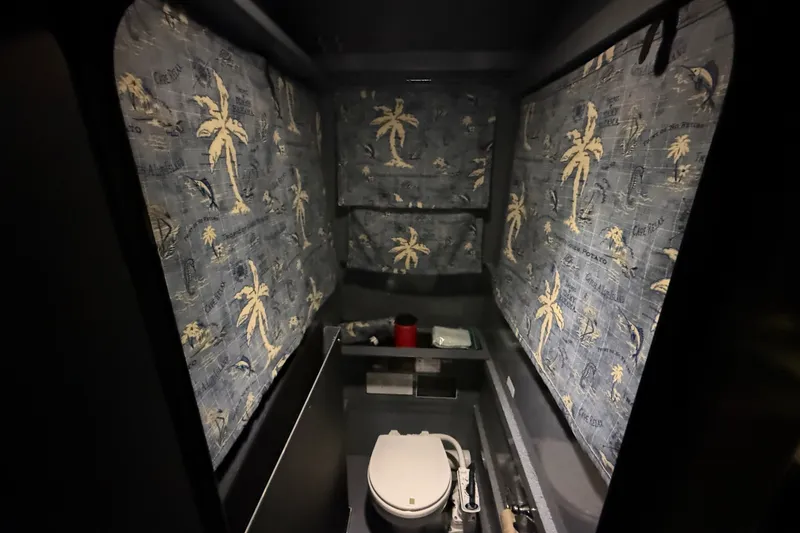 Slide: The Image of Interior of 2012 Wooldridge 29 Super Sport Pilothouse bathroom with tropical-themed curtains. - 21