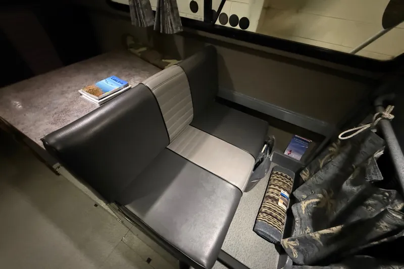 Slide: The Image of Interior seating of 2012 Wooldridge 29 Super Sport Pilothouse with table and books. - 17