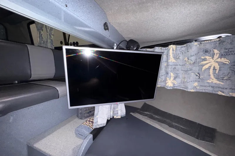 Slide: The Image of Interior of 2012 Wooldridge 29 Super Sport Pilothouse with TV and tropical curtains. - 28