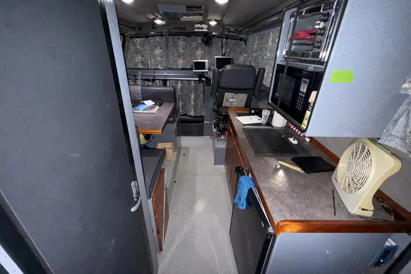 Slide: The Image of Interior of 2012 Wooldridge 29 Super Sport Pilothouse with seating, table, and control panel. - 8
