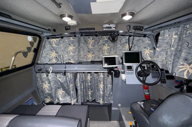 Slide: The Image of Interior of 2012 Wooldridge 29 Super Sport Pilothouse with nautical equipment and palm tree curtains. - 13