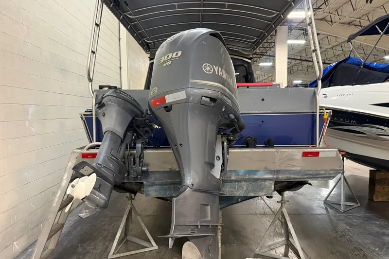Slide: The Image of 2012 Wooldridge 29 Super Sport Pilothouse with Yamaha outboard motor in a showroom. - 4