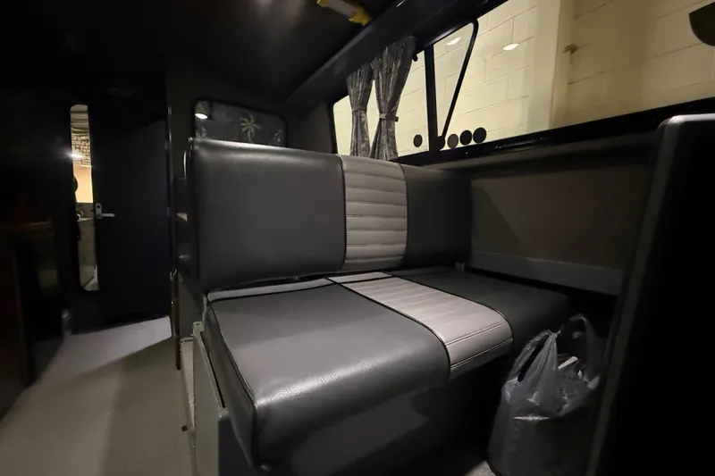 Slide: The Image of Interior of 2012 Wooldridge 29 Super Sport Pilothouse with gray seating and window curtains. - 30