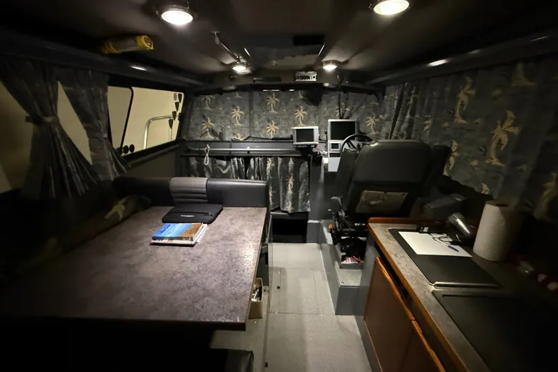Slide: The Image of Interior of 2012 Wooldridge 29 Super Sport Pilothouse with table, seating, and navigation equipment. - 22