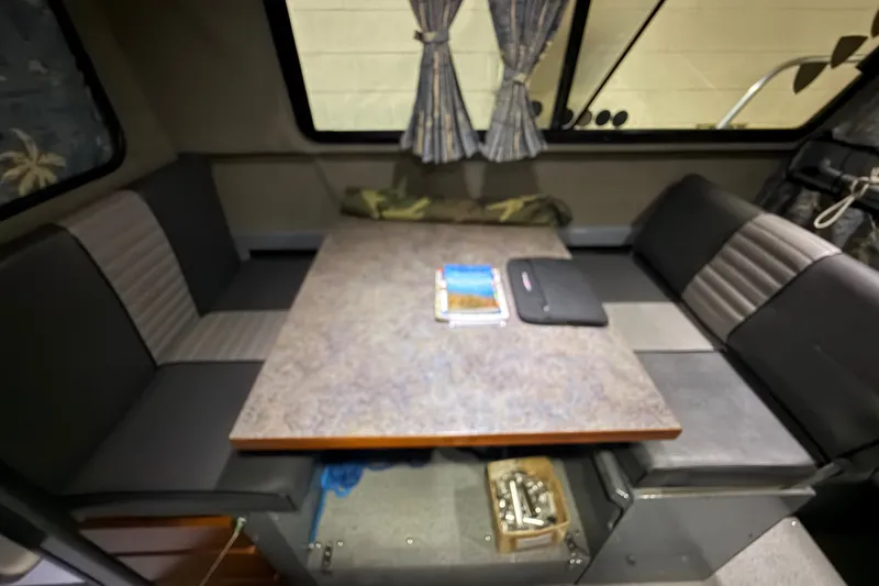 Slide: The Image of Interior of 2012 Wooldridge 29 Super Sport Pilothouse with table and seating area. - 24
