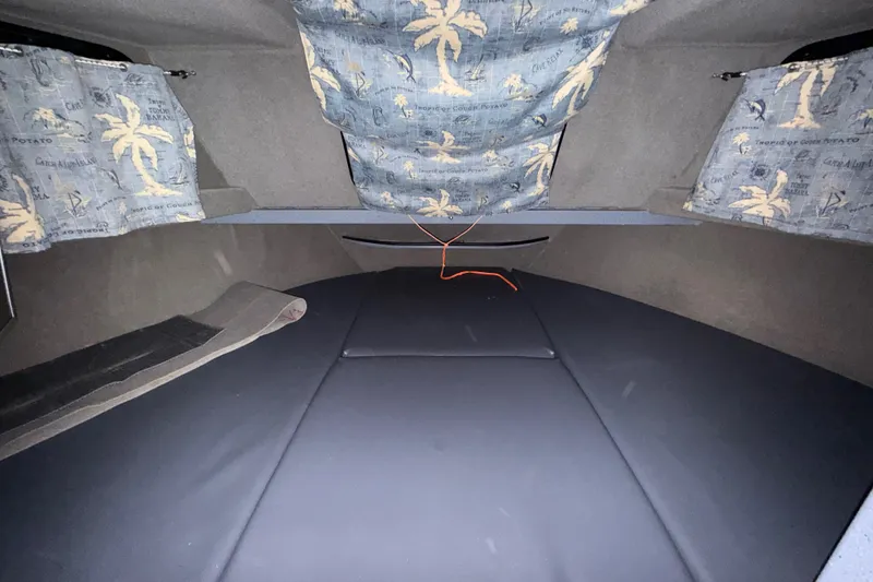 Slide: The Image of Interior cabin of 2012 Wooldridge 29 Super Sport Pilothouse with tropical-themed curtains. - 25