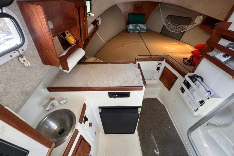 Slide: The Image of Cozy interior of 2005 Atlas Boat Works Acadia 25 with kitchenette and sleeping area. - 29
