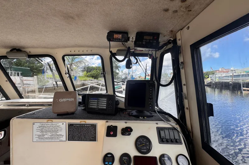 Slide: The Image of Interior view of 2005 Atlas Boat Works Acadia 25 with navigation equipment and gauges. - 15