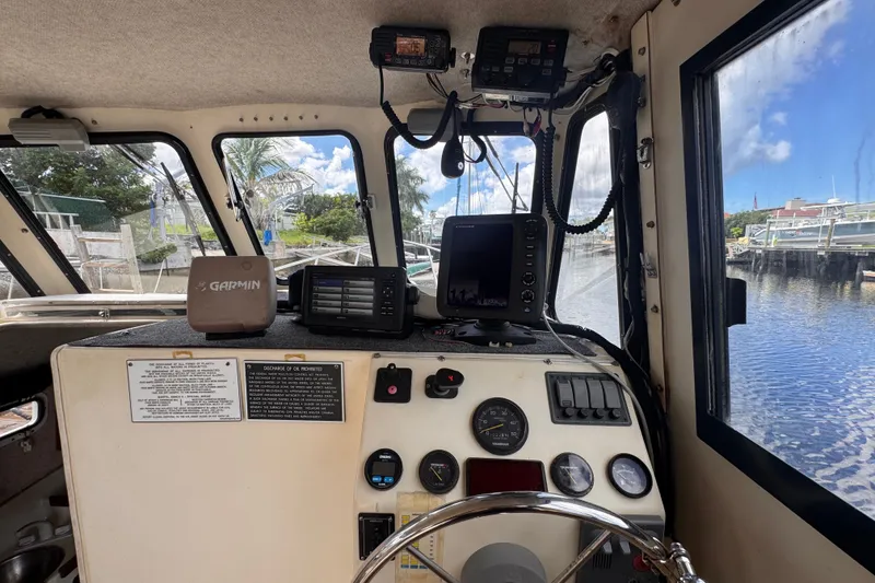Slide: The Image of Interior view of 2005 Atlas Boat Works Acadia 25 helm with navigation equipment. - 14