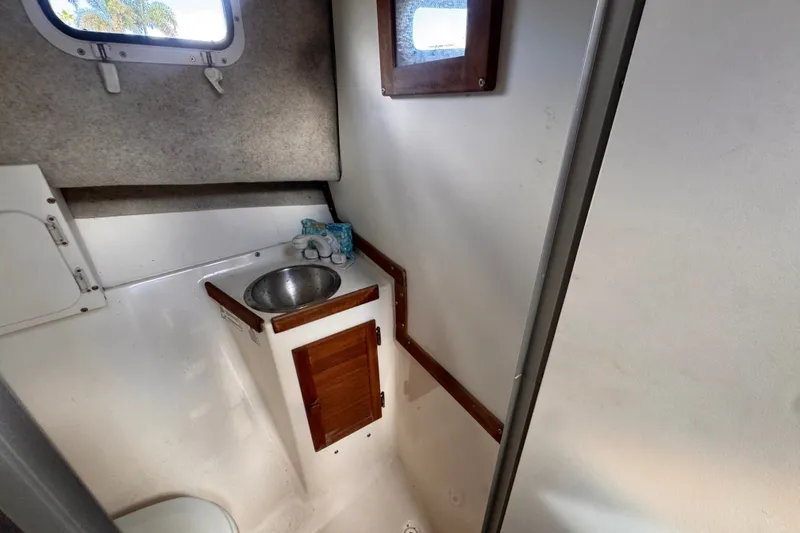 Slide: The Image of Compact bathroom interior of 2005 Atlas Boat Works Acadia 25, featuring sink and window. - 38