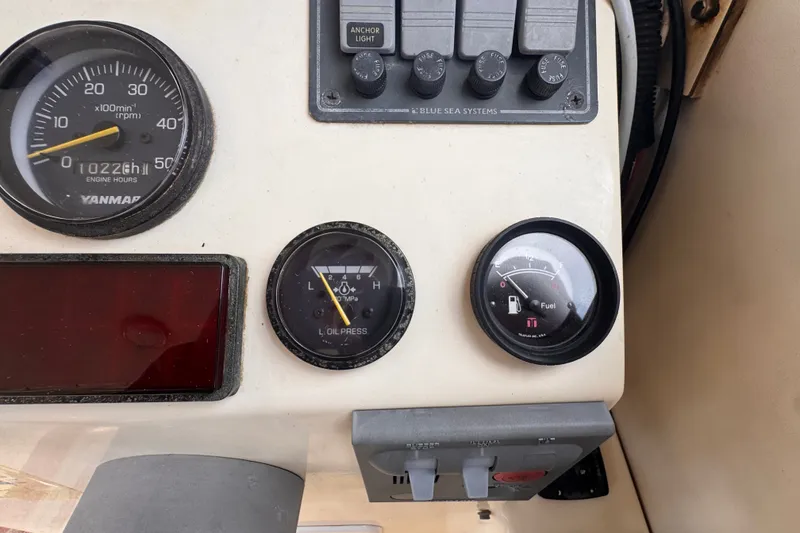 Slide: The Image of Dashboard of 2005 Atlas Boat Works Acadia 25 with gauges and controls. - 16