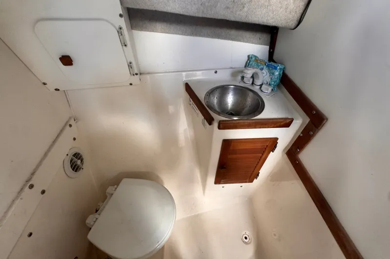 Slide: The Image of Compact bathroom in 2005 Atlas Boat Works Acadia 25, featuring toilet and sink. - 39