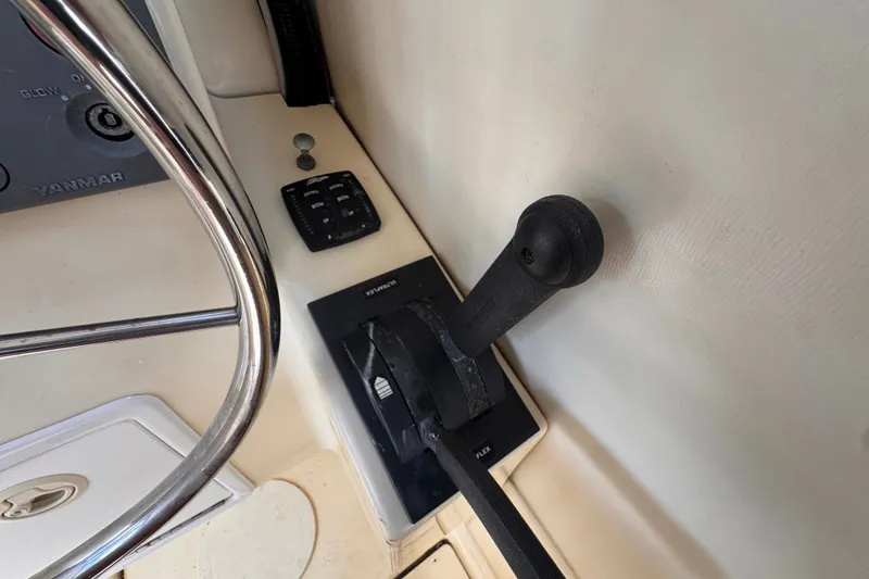 Slide: The Image of Close-up of 2005 Atlas Boat Works Acadia 25 throttle and steering wheel. - 25