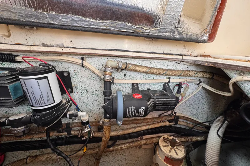 Slide: The Image of Engine compartment of a 2005 Atlas Boat Works Acadia 25, showing mechanical components and wiring. - 48