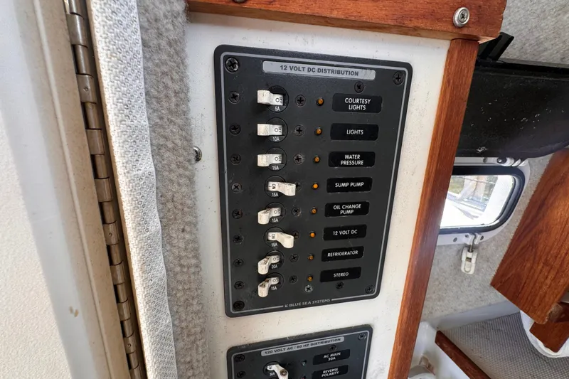Slide: The Image of Electrical panel on a 2005 Atlas Boat Works Acadia 25, featuring various switches and fuses. - 27
