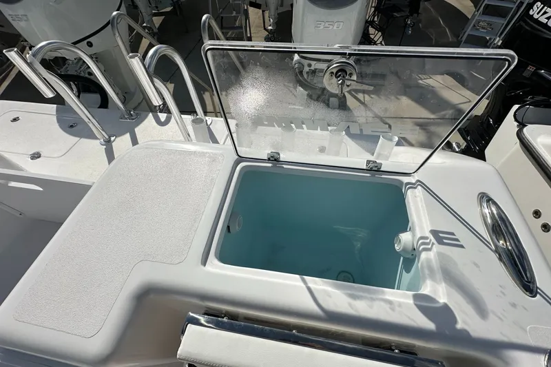 Slide: The Image of 2026 Twin Vee 340 GFX CC boat with open storage compartment and visible engine. - 16