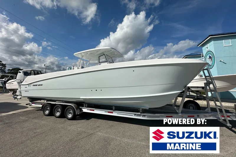 The Image of 2026 Twin Vee 340 GFX CC boat on trailer, powered by Suzuki Marine. - 0