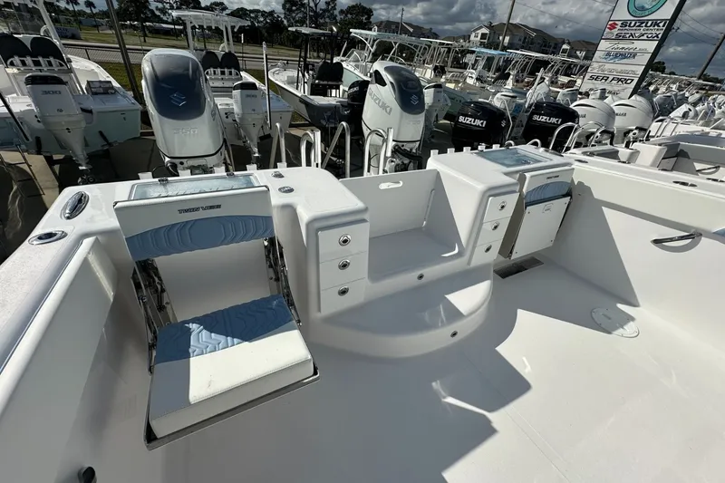 Slide: The Image of 2026 Twin Vee 340 GFX CC boat interior with seating and storage, featuring Suzuki engines. - 14