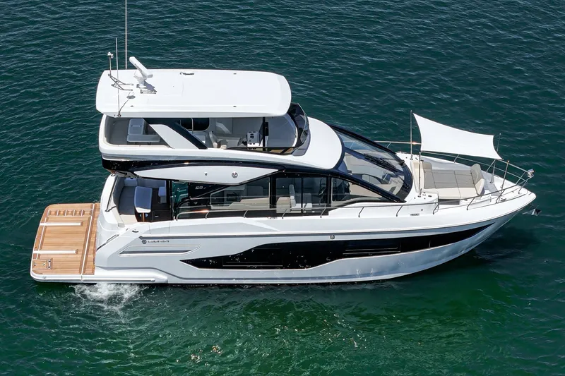 Slide: The Image of 2027 Cruisers Yachts 50 Fly luxury yacht cruising on open water. - 11