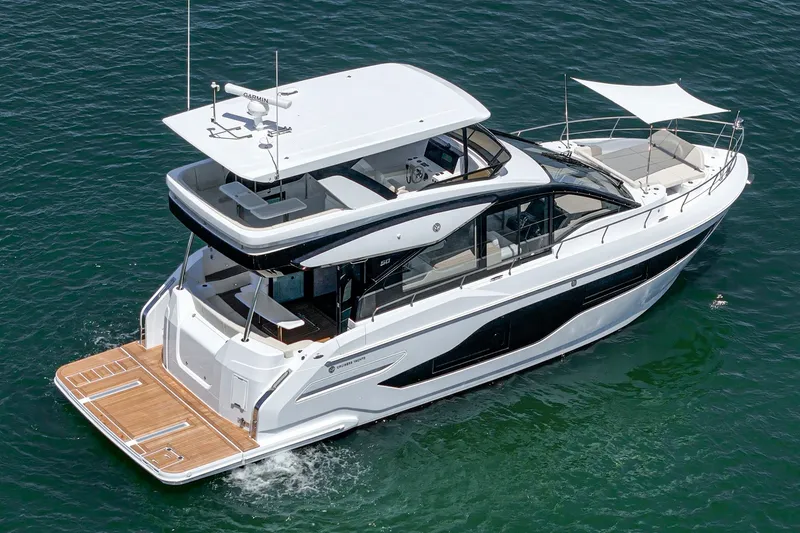 Slide: The Image of 2027 Cruisers Yachts 50 Fly luxury yacht on open water, showcasing sleek design. - 6