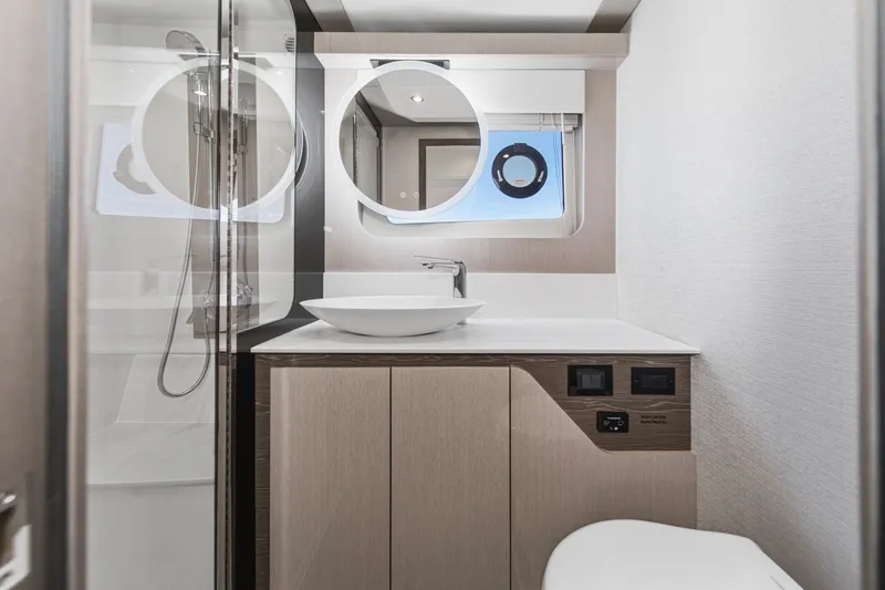 Slide: The Image of Modern bathroom interior on 2027 Cruisers Yachts 50 Fly, featuring sleek design and fixtures. - 79