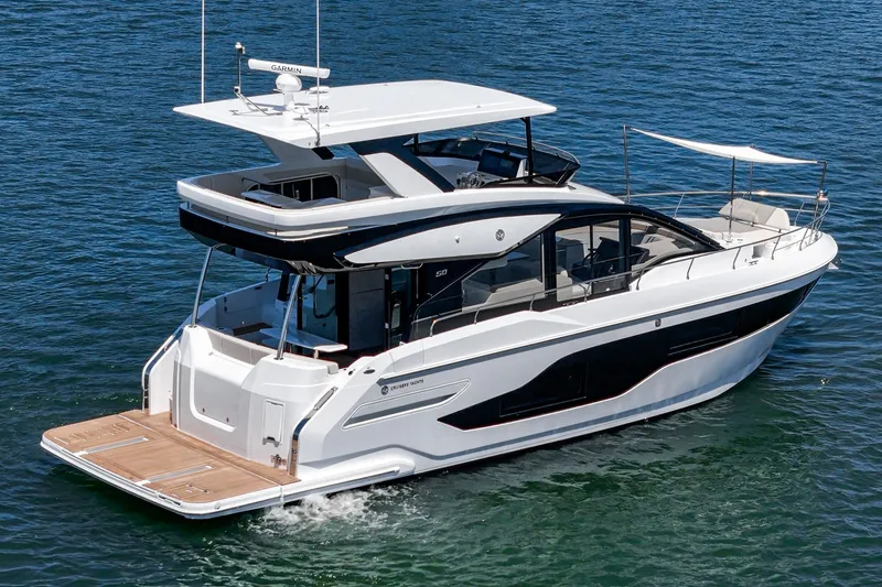 Slide: The Image of 2027 Cruisers Yachts 50 Fly luxury yacht cruising on open water. - 7