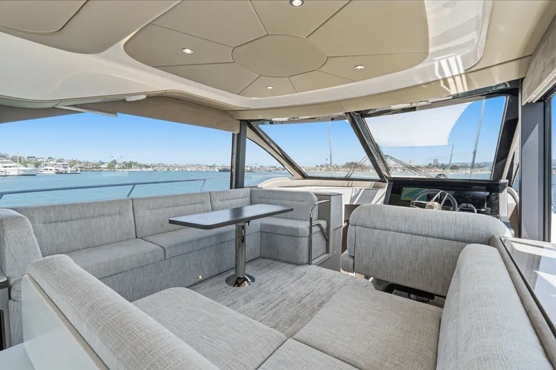 Slide: The Image of Luxurious interior of 2027 Cruisers Yachts 50 Fly with panoramic windows and plush seating. - 62