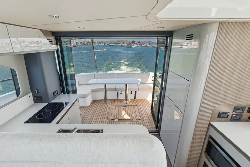 Slide: The Image of Luxurious interior of 2027 Cruisers Yachts 50 Fly with modern kitchen and scenic ocean view. - 55