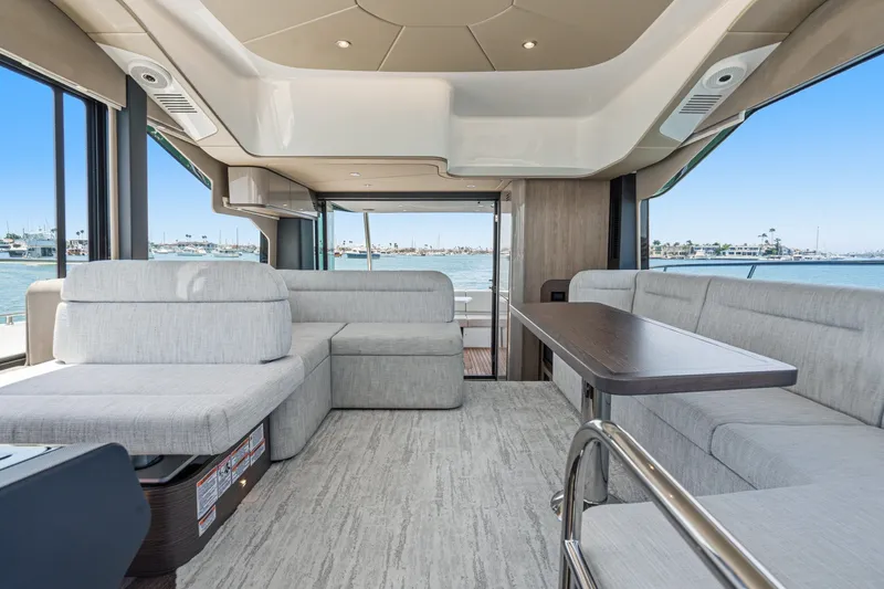Slide: The Image of Luxurious interior of 2027 Cruisers Yachts 50 Fly with modern seating and ocean view. - 68