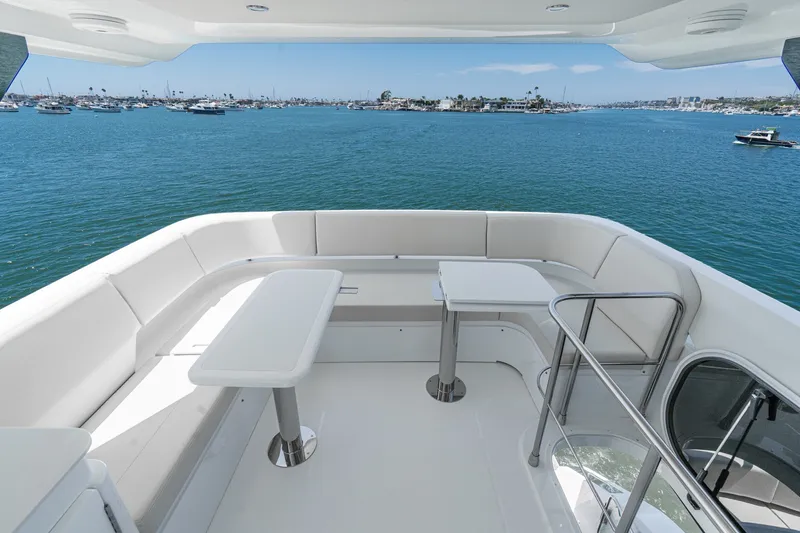 Slide: The Image of Luxurious 2027 Cruisers Yachts 50 Fly deck with seating, overlooking serene waters. - 42